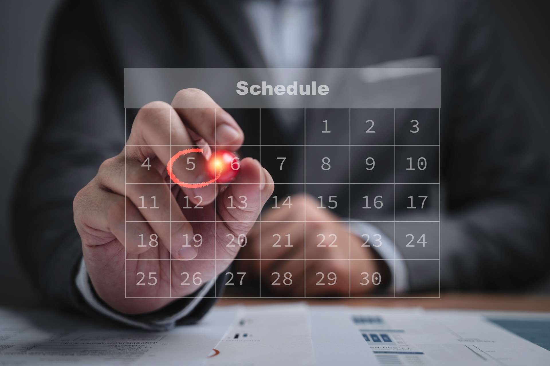 Businessman using pen to writing circle mark on virtual calendar agenda of booking and appointment meeting concept.